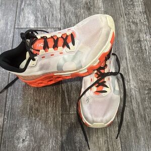 On Running White and Orange Athletic Shoes